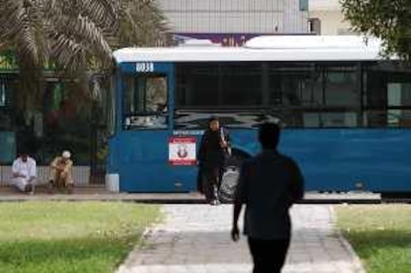 Abu Dhabi - July 3, 2008. A bus pulls up to a stop on Airport rd and Al Saada street. ( Philip Cheung / The National ) *** Local Caption ***  PC0251-Bus.jpgPC0251-Bus.jpg