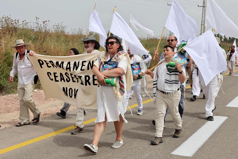 US and Israeli rabbis and rabbinical students from the group 'Rabbis for Ceasefire' joined by peace activists, march toward the Erez crossing on the border with northern Gaza Strip symbolically carrying bags of rice and white flags, to call for a permanent ceasefire, on April 26. AFP