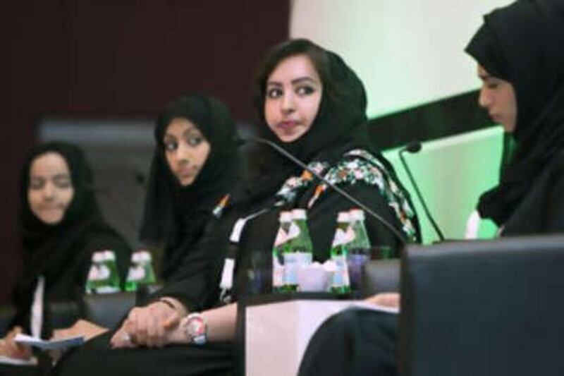 Abu Dhabi University students answer questions at the Emiratisation Forum yesterday.