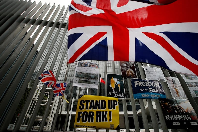 British flags flutter next to protest placards placed by protesters outside the Central Government Office building in Hong Kong on Thursday, July 4, 2019. A Hong Kong pro-democracy lawmaker expressed fears Thursday that the situation could worsen after police announced the arrests of more than a dozen people following protests earlier this week. (AP Photo/Andy Wong)