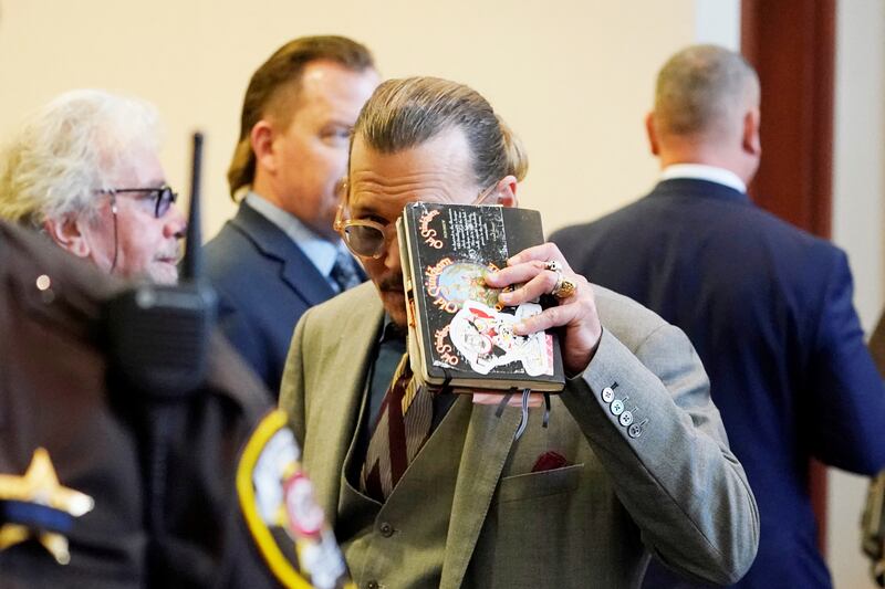  Depp looks toward the courtroom gallery as they take a break. Reuters