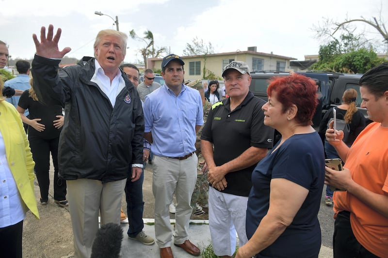 US President Donald Trump and First Lady Melania Trump visit residents affected by Hurricane in Guaynabo, west of San Juan, Puerto Rico on October 3, 2017.
Nearly two weeks after Hurricane Maria thrashed through the US territory, much of the islands remains short of food and without access to power or drinking water. / AFP PHOTO / MANDEL NGAN