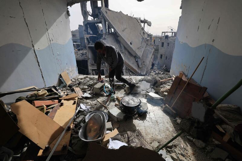 A Palestinian man surveys the damage inside an apartment in Khan Younis, southern Gaza, following weeks of Israeli bombardment.  AFP