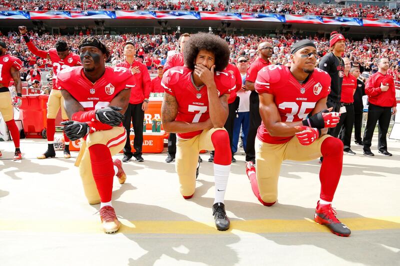 epa06758083 (FILE) - San Francisco 49ers back-up quarterback Colin Kaepernick (C), San Francisco 49ers outside linebacker Eli Harold (L), and San Francisco 49ers free safety Eric Reid (R) take a knee during the US national anthem before the NFL game between the Dallas Cowboys and the San Francisco 49ers at Levi's Stadium in Santa Clara, California, USA, 02 October 2016 (reissued 23 May 2018). According to media reports, NFL team owners approved a policy for players to stand and not to kneel during the national anthem.  EPA/JOHN G MABANGLO *** Local Caption *** 53047788