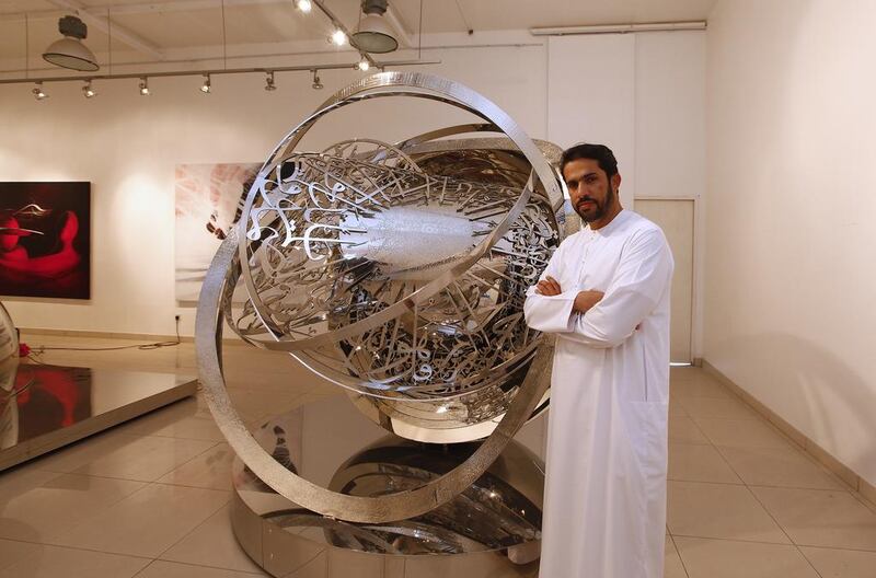 Mattar Bin Lahej with a metal artwork he created at his gallery in Dubai. Jeffrey E Biteng / The National