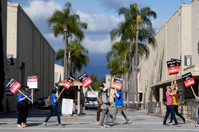 Members of the Writers Guild of America outside an entrance to Warner Bros on Tuesday. AP Photo