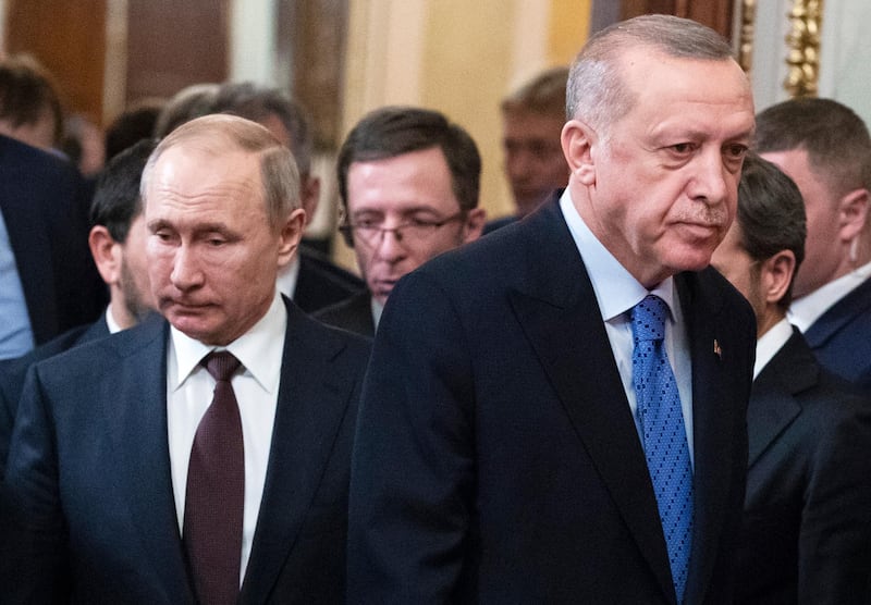 Russian President Vladimir Putin, left, and Turkish President Recep Tayyip Erdogan arrive for a news conference after their talks in the Kremlin, in Moscow, Russia, Thursday, March 5, 2020.  Russian President Vladimir Putin and his Turkish counterpart, Recep Tayyip Erdogan, say they have reached agreements that could end fighting in northwestern Syria. (AP Photo/Pavel Golovkin, Pool)