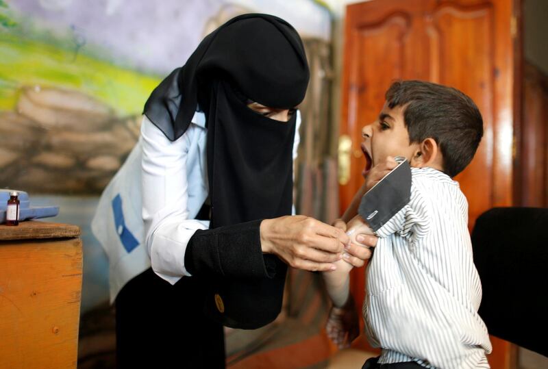 FILE PHOTO: A boy reacts as he receives a vaccination for measles and rubella at his school as a six-day immunization campaign kicks off in Sanaa, Yemen February 9, 2019. REUTERS/Khaled Abdullah/File Photo