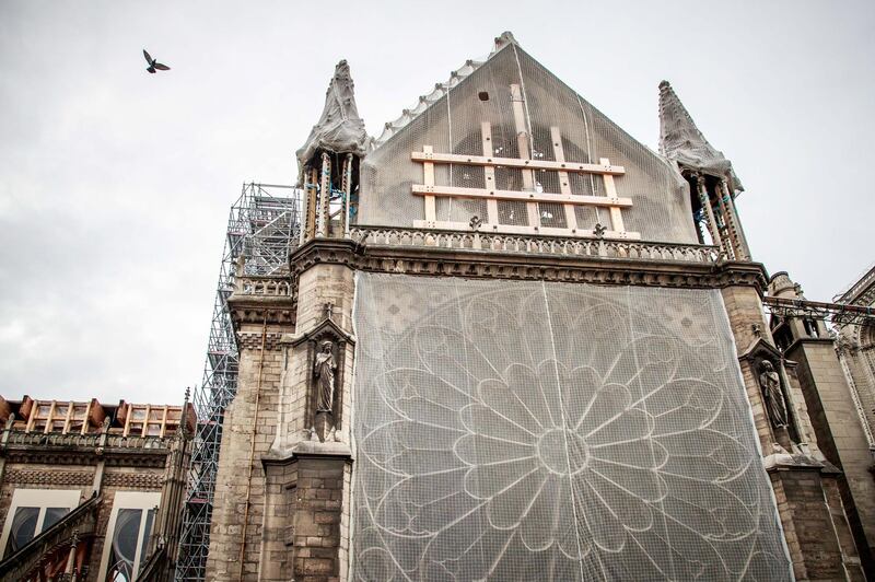 epa07922042 A view of the north side of the Notre-Dame Cathedral during consolidation works, six months after a fire ravaged the roof of the most visited monument in the French capital, in Paris, France, 15 October 2019. Six months after the historic monument was badly damaged by a huge fire last 15 April, consolidation works are continuing before the start of the restoration.  EPA/CHRISTOPHE PETIT TESSON