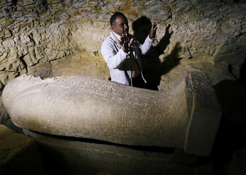 Egyptian antiquities worker gestures near a coffin inside the recently discovered burial site in Minya, Egypt. Mohamed Abd El Ghany / Reuters