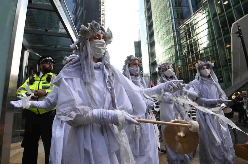 Environmental protesters demonstrate in the City of London. Protests were held on Friday across 26 countries, days before world leaders meet in Glasgow for Cop26. EPA