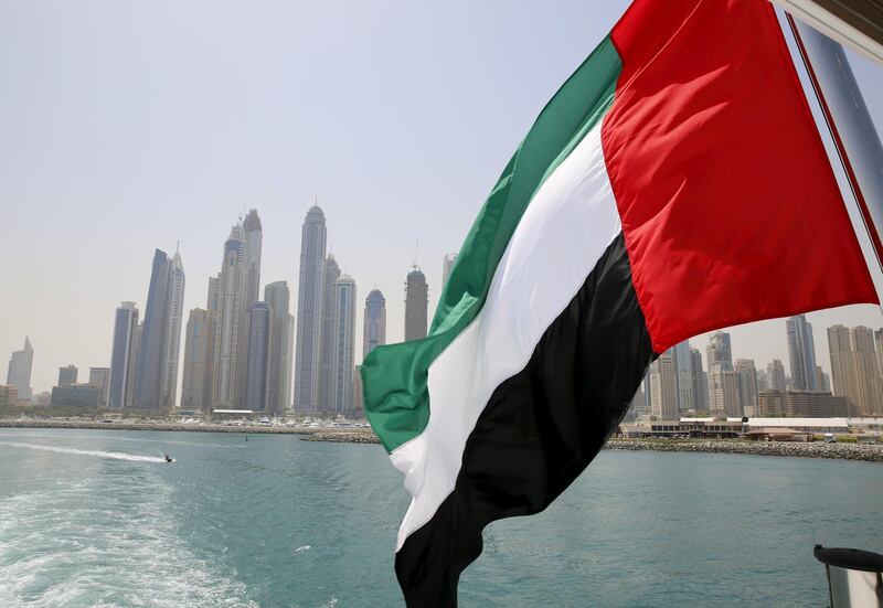 FILE PHOTO: UAE flag flies over a boat at Dubai Marina, Dubai, United Arab Emirates May 22, 2015. REUTERS/Ahmed Jadallah/File Photo