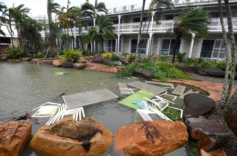 Outdoor furniture blown into a pool at a motel in Airlie Beach, a resort town in Queensland state located south of Townsville in Australia. Dan Peled / AAP /  via Reuters