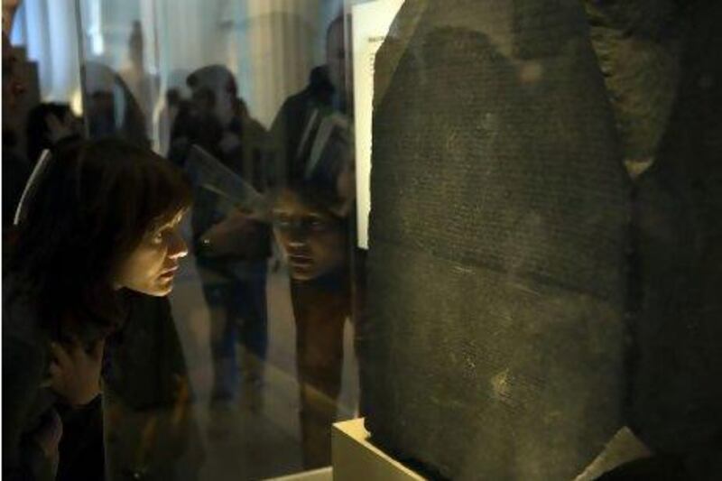 A visitor at the British Museum in London inspects the Rosetta Stone. Brian Harris / Rex Features