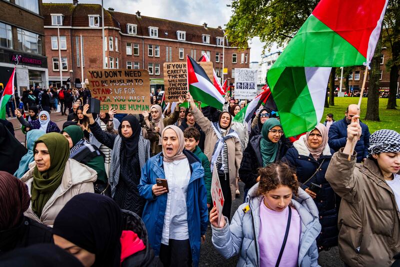 Demonstrators hold Palestinian flags and placards during a rally in The Hague, the Netherlands. AFP
