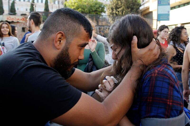 A protester calms another who was overwhelmed with tears in Beirut. AP Photo