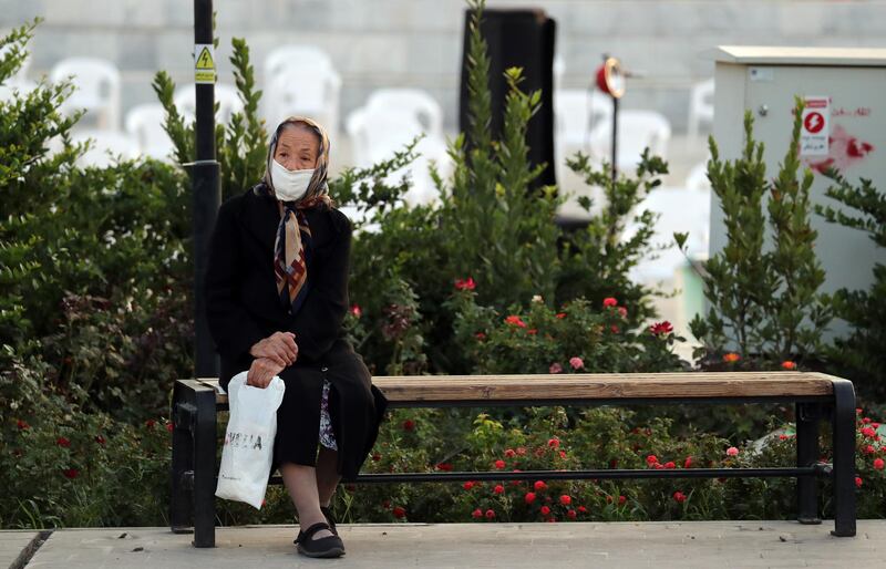 An Iranian elderly woman sits on a bench in a street of Tehran, Iran. EPA