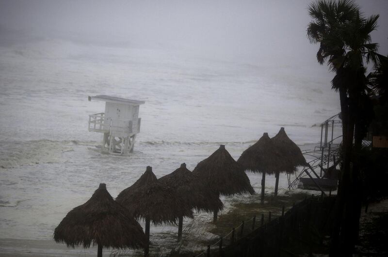Waves surge onto shore past a lifeguard stand in Panama City Beach. Bloomberg