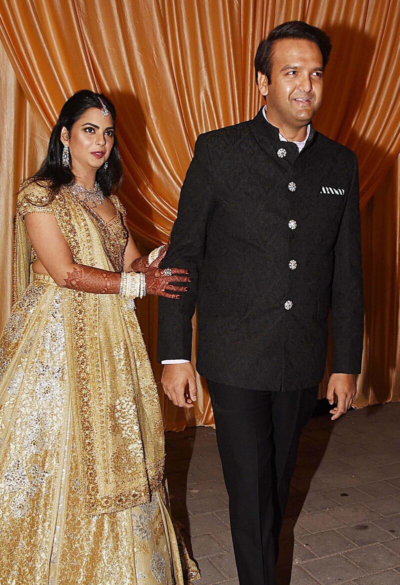 Isha Ambani (L) and Anand Piramal (R), son of Indian billionaire industrialist Ajay Piramal, during their second Mumbai reception