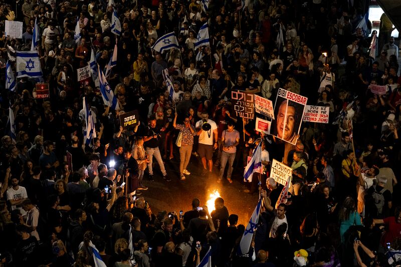 Protesters light torches during a demonstration calling for a hostage deal with Hamas in Tel Aviv. Getty Images