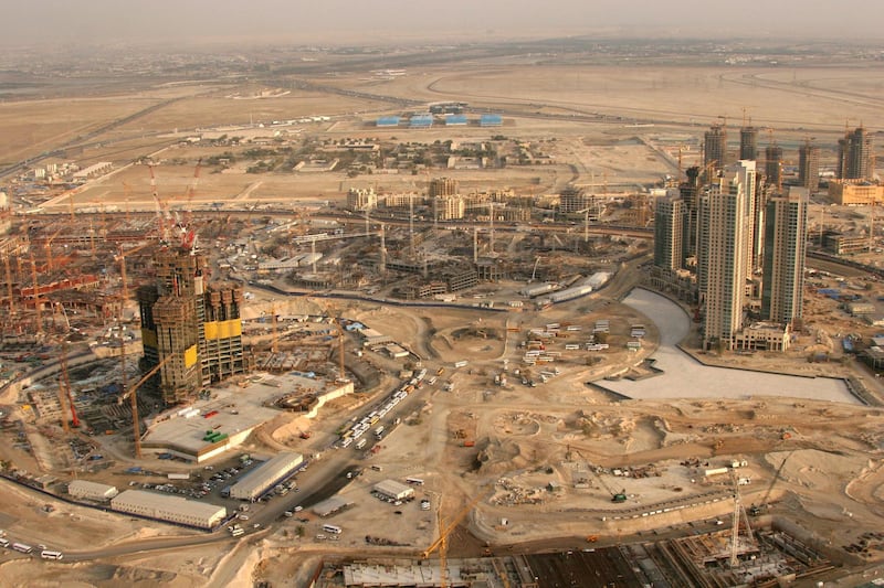 A general view shows 29 January 2006 construction work at the site of Emaar's main project, the Burj Dubai tower, in the heart of the Gulf emirate. When completed, Emaar's Burj Dubai will stand some 800 metres (2,500 feet) high, comfortably taller than any building currently standing in the world. The Dubai-based real estate giant, which has a market capitalisation of more than 40 billion dollars, announced "record annual profits of 4.731 billion dirhams for the year ended December 31, 2005." The land in the background is the site of another major Emaar project, known as Business Bay. AFP PHOTO/NASSER YOUNES (Photo by NASSER YOUNES / AFP)