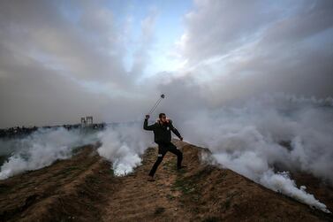 epaselect epa07372985 A Palestinian protester throw stones by his slingshot during clashes after Friday protests near the border between Israel and Gaza Strip, east Gaza, 15 February 2019. According to reports, 20 Palestinian protesters were wounded during the clashes along the border between Gaza Strip and Israel. Palestinian protesters call for the right of Palestinian refugees across the Middle East to return to homes they fled in the war surrounding the 1948 creation of Israel. EPA/MOHAMMED SABER