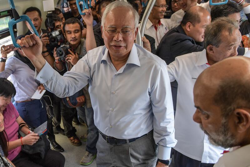 Najib Razak on board the Malaysia Mass Rapid Transit train during its phase one launching on the outskirts of Kuala Lumpur in 2016. AFP