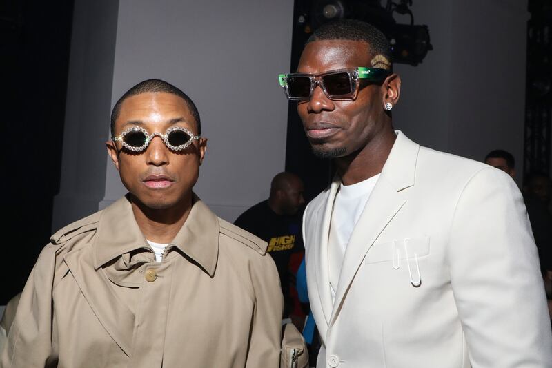 Musician Pharrell Williams, left, and Paul Pogba at Paris Fashion Week. AP