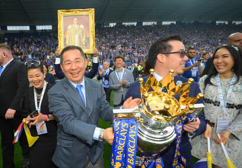 LEICESTER, ENGLAND - MAY 07:  Leceister City owner Vichai Srivaddhanaprabha (L) and son Aiyawatt Srivaddhanaprabha hold the Premier League Trophy after the Barclays Premier League match between Leicester City and Everton at The King Power Stadium on May 7, 2016 in Leicester, United Kingdom.  (Photo by Michael Regan/Getty Images)