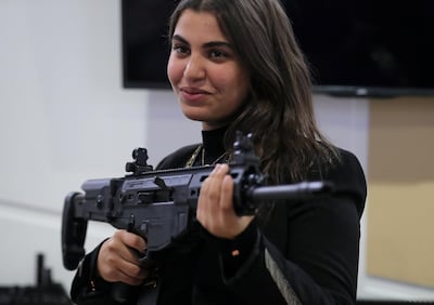 A visitor holds a weapon at the Italian stand during the last day of Egypt Defense Expo, showcasing military systems and hardware, in Cairo, Egypt, December 5, 2018. REUTERS/Mohamed Abd El Ghany
