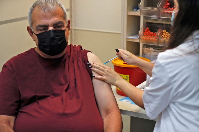 An Israeli health worker administers a third dose of Pfizer-BioNTech's Covid-19 vaccine at the Maccabi Health Service in Jerusalem on Friday. AFP