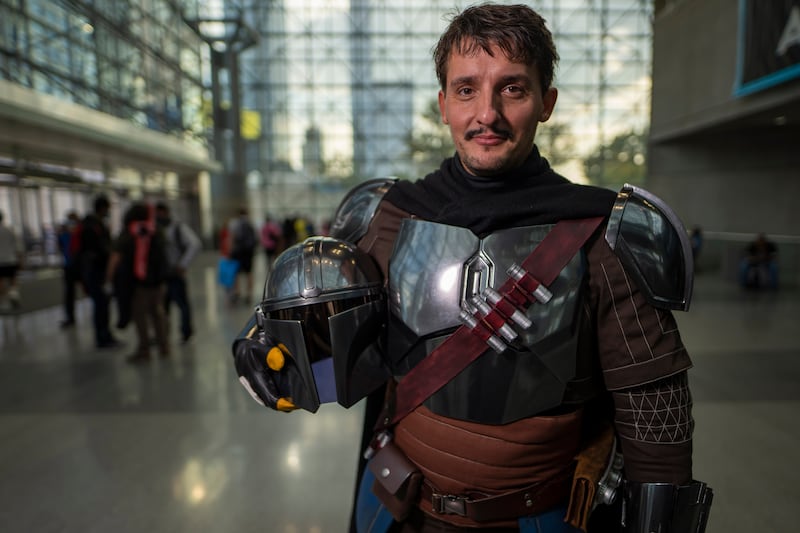 An attendee dressed as the Mandalorian poses during New York Comic Con. Charles Sykes / Invision / AP