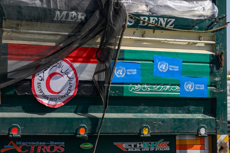 Stickers of the Egyptian Red Crescent and UNRWA as well as the Egyptian and Saudi flags are displayed on a humanitarian aid lorry at Israel's Kerem Shalom crossing into the Gaza Strip. Getty Images