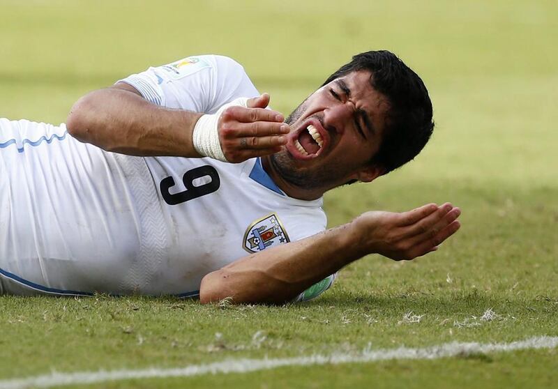 Uruguay's Luis Suarez reacts after clashing with Italy's Giorgio Chiellini during their 2014 World Cup Group D match at the Dunas arena in Natal on June 24, 2014. Tony Gentile / Reuters
