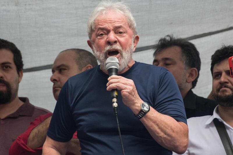 Brazilian ex-president (2003-2011) Luiz Inacio Lula da Silva (L) speaks during a Catholic mass in memory of Lula's late wife Marisa Leticia, at the metalworkers' union building in Sao Bernardo do Campo, in metropolitan Sao Paulo, Brazil, on April 7, 2018.
Brazil's election frontrunner and controversial leftist icon said Saturday that he will comply with an arrest warrant to start a 12-year sentence for corruption. "I will comply with their warrant," he told a crowd of supporters. / AFP PHOTO / NELSON ALMEIDA