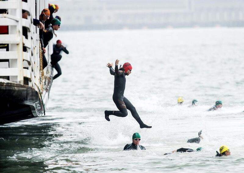 A swimmer jumps from the San Francisco Belle at the start of the 34th annual Escape from Alcatraz Triathlon in San Francisco, California, on Sunday. Participants swim 1.5 miles (2.4 km) to shore, bike 18 miles (30 km) and finish with an 8 mile (13 km) run. Noah Berger / Reuters / June 1, 2014