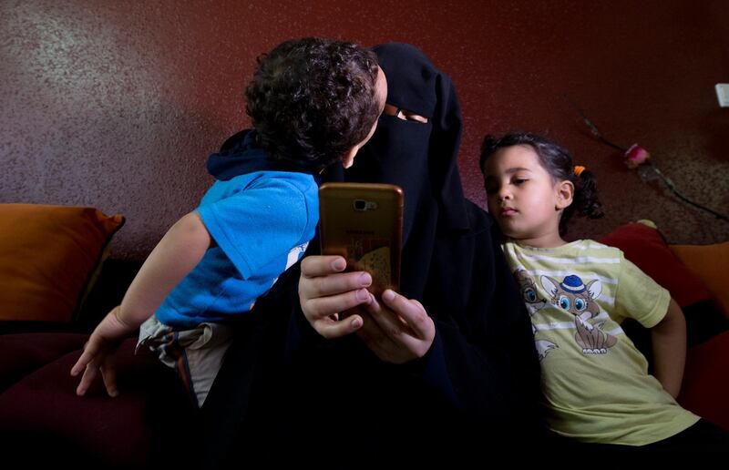 Muna Awad, mother of 5-year-old Aisha a-Lulu, with two of her children at the family home in Burij refugee camp, central Gaza Strip. The death of the Palestinian girl has drawn attention to Israel's vastly complex system for issuing travel permits to Gaza medical patients and their families. AP Photo