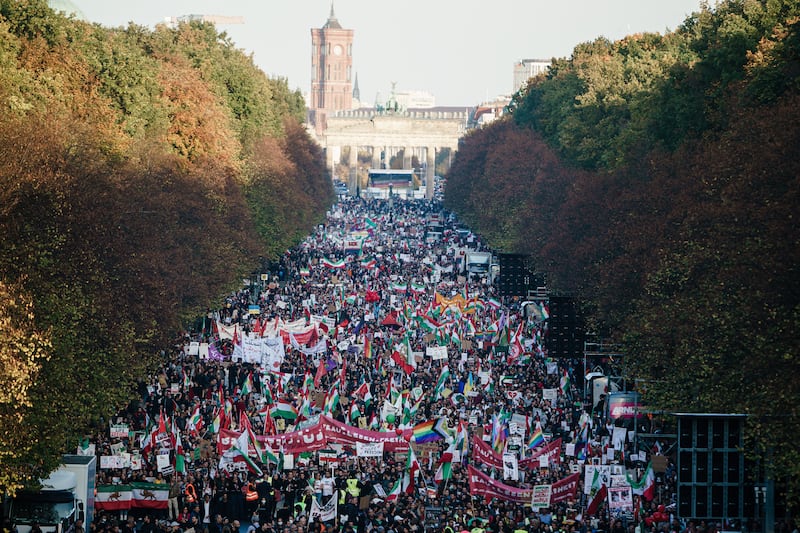 Demonstrators gather in front of the Brandenburg Gate during a rally in solidarity with Iranian protests following the death of Amini, in Berlin. EPA