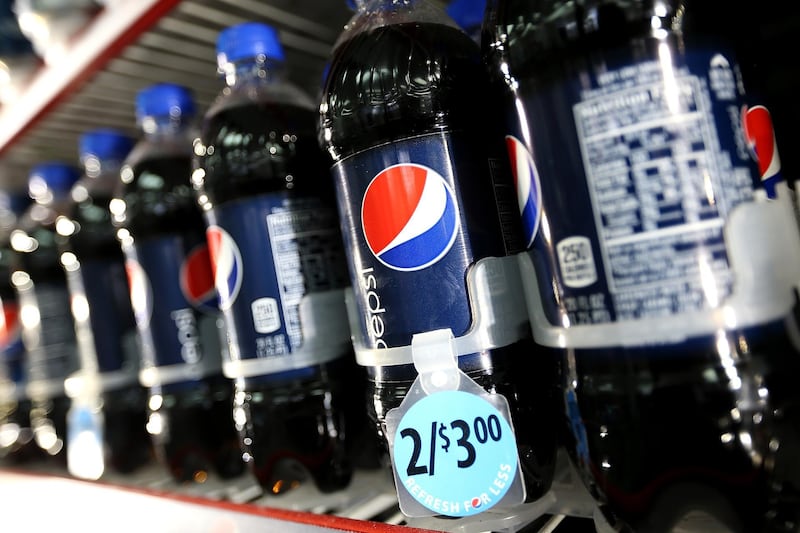 (FILES) In this file photo taken on March 25, 2013 bottles of Pepsi sit in a cooler at a gas station in San Francisco, California. - PepsiCo said August 20, 2018 it was buying Israeli company SodaStream for $3.2 billion as the US beverage giant contends with falling demand for sugar-laden soft drinks among health-conscious consumers. SodaStream makes machines that carbonate home tap water, and both PepsiCo and its arch-rival Coca-Cola have been diversifying away from their mainstay fizzy drinks in part to counter the onset of anti-obesity sugar taxes around the world. (Photo by JUSTIN SULLIVAN / GETTY IMAGES NORTH AMERICA / AFP)