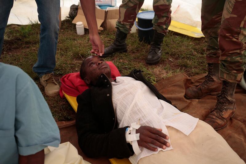 A rescued woman lies in a makeshift clinic for medical attention in Chimanimani. EPA