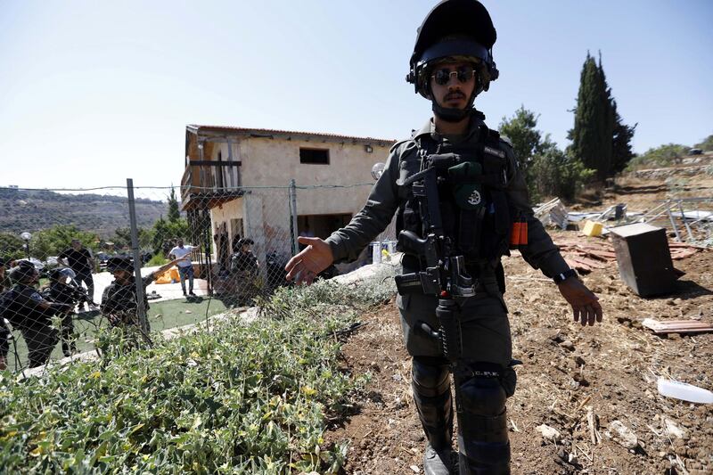 An Israeli soldier stands guard as authorities demolish the structure in Bethlehem. According to Palestinian reports, the building belonging to Ramzi Qaisiyya EPA