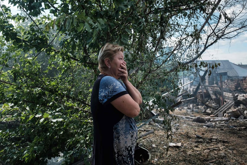 A woman surveys the devastation caused by an air strike in Bakhmut. AFP