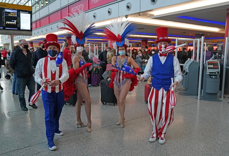 Performers entertain passengers at Heathrow Airport. Thousands of travellers are jetting off on transatlantic flights for long-awaited reunions with relatives and friends