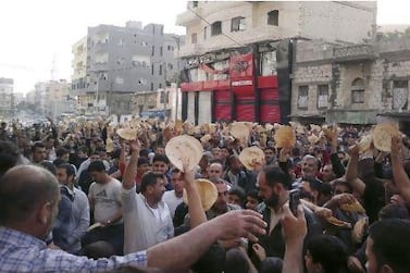 Syrian demonstrators carry bread loaves during a protest against President Bashar Al Assad's regime in the coastal town of Banias in 2011. 