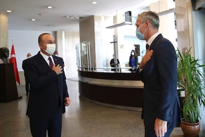 Turkey's Foreign Minister Mevlut Cavusoglu, left, greets NATO Secretary-General Jens Stoltenberg prior to their meeting in Ankara, Turkey, Monday, Oct. 5, 2020. The fighting between Armenian and Azerbaijani forces over the separatist territory of Nagorno-Karabakh resumed Monday and Stoltenberg said the 30-country military alliance is "deeply concerned by the escalation of hostilities," urging Turkey to help end the fighting. (Fatih Aktas/Turkish Foreign Ministry via AP, Pool)