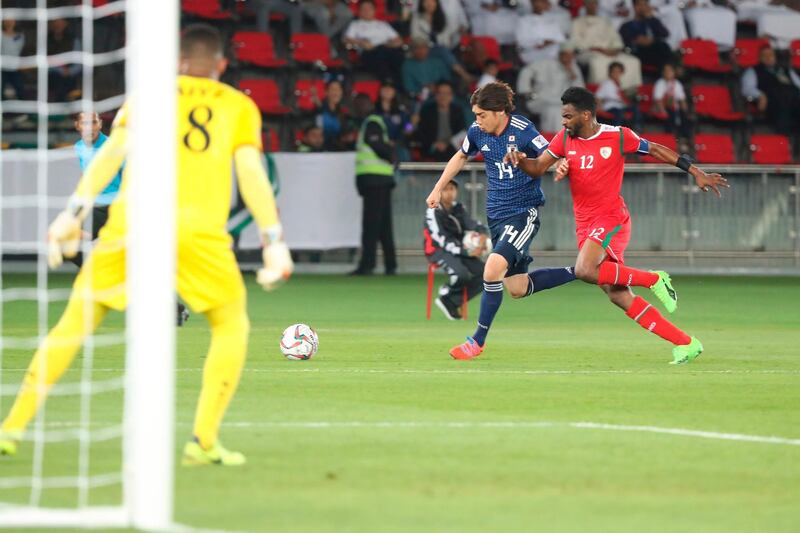 Japan's Junya Ito, left, fights for the ball with Oman's Ahmed Faraj Abdulla Rawahi. AFP