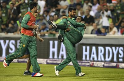 MANCHESTER, ENGLAND - SEPTEMBER 07:  Shoaib Malik of Pakistan carries Babar Azam off injured during the NatWest International T20 match between England and Pakistan at Old Trafford on September 7, 2016 in Manchester, England.  (Photo by Alex Livesey/Getty Images)