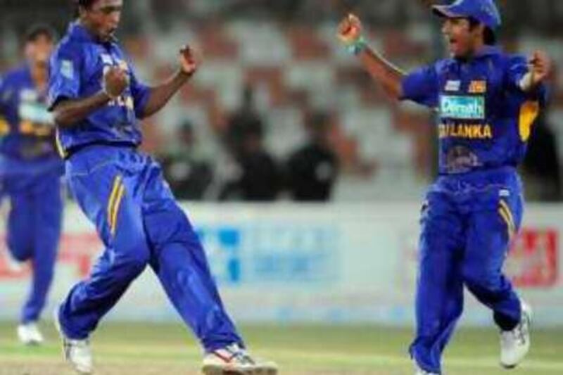 Sri Lankan spinner Ajantha Mendis (L) celebrates with an unidentified teammate after taking the wicket off unseen Indian cricketer Irfan Pathan during the Asia Cup final between India and Sri Lanka at the National Cricket Stadium in Karachi on July 6, 2008. Sensational spinner Ajantha Mendis took six wickets for just nine runs to help Sri Lanka beat India by 100 runs in the final here on Sunday to successfully defend the Asia Cup title.  AFP PHOTO/Aamir QURESHI *** Local Caption ***  840533-01-08.jpg