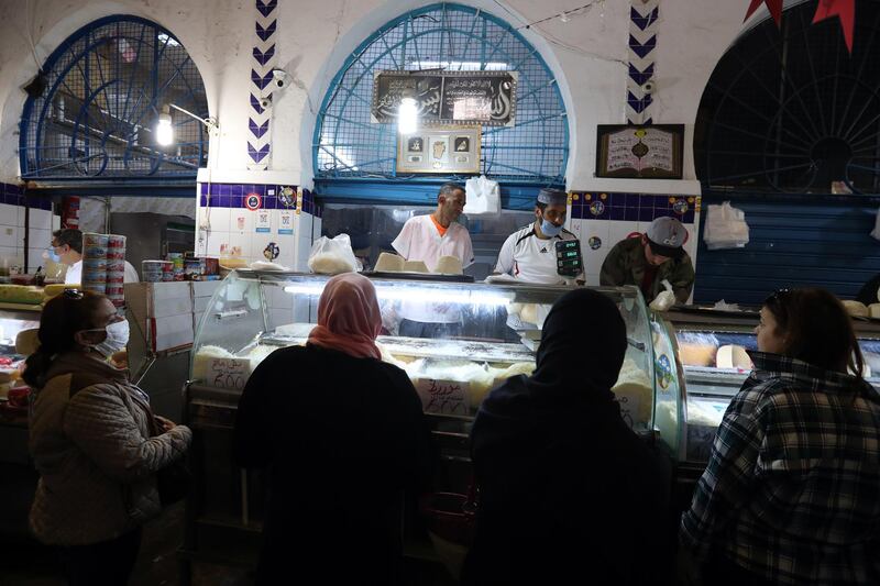 Tunisians buy cheese on the first day of Ramadan at a market in Tunis, Tunisia, 24 April 2020. EPA