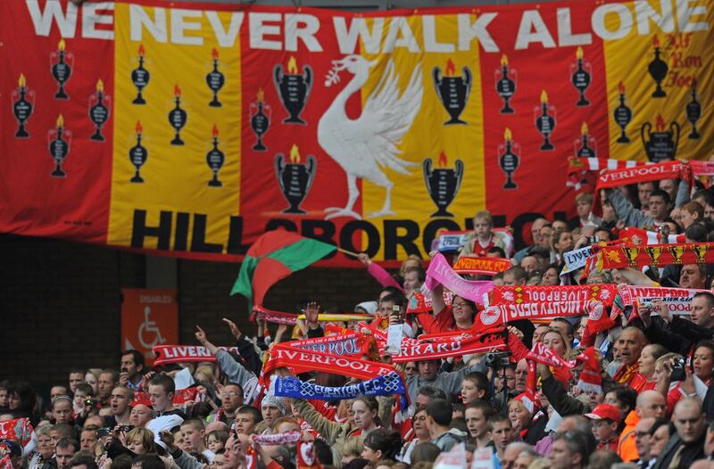 Liverpool football club supporters sing 'You'll Never Walk Alone' during a memorial service to mark the twentieth anniversary of the Hillsborough disaster at Anfield in Liverpool. AFP